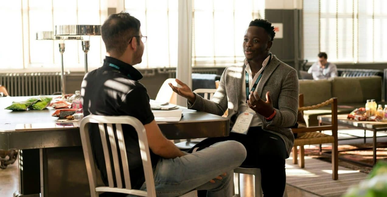 Recruiter and hiring manager reviewing hiring process post-hire